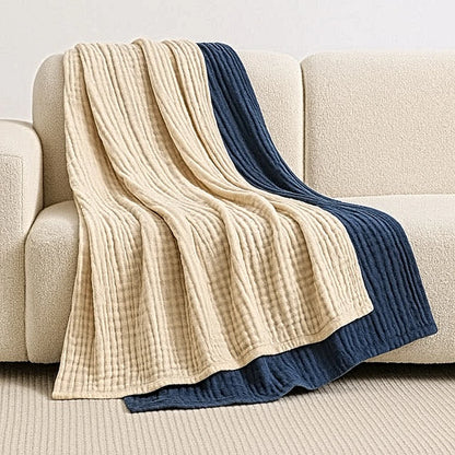 Mussora™ coperta in mussola sul divano